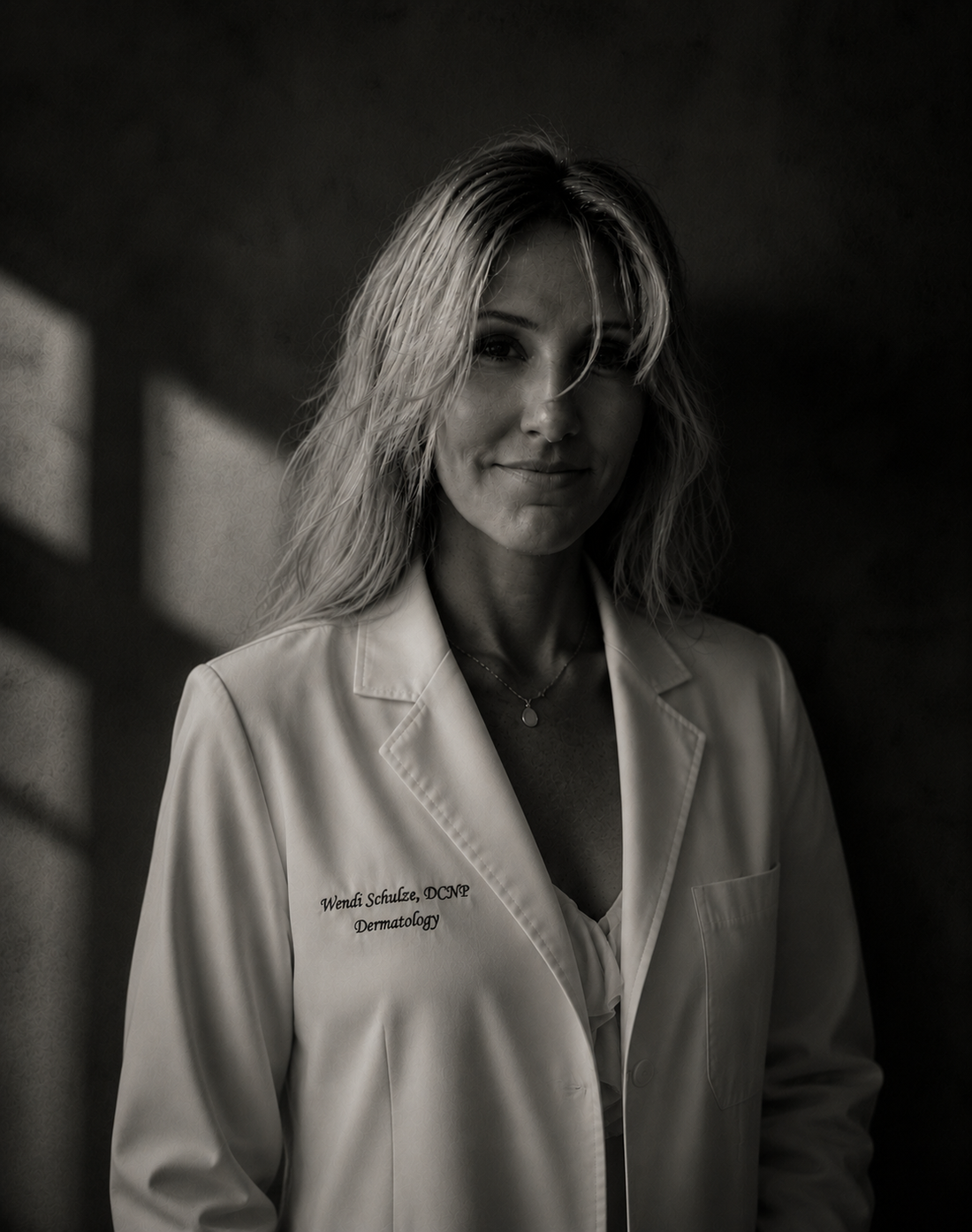 Wendi Schulze, DCNP, in her white dermatology coat